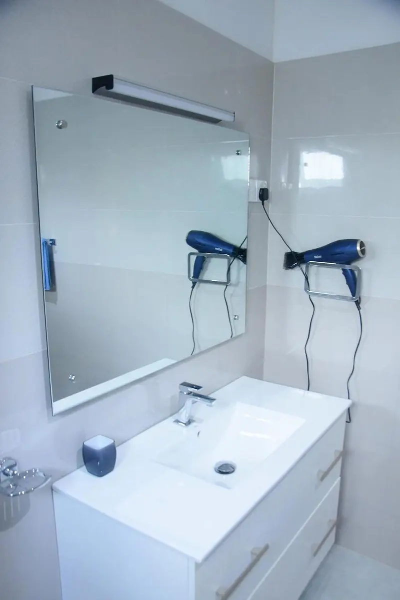 Bathroom basin with mirror and hairdryer