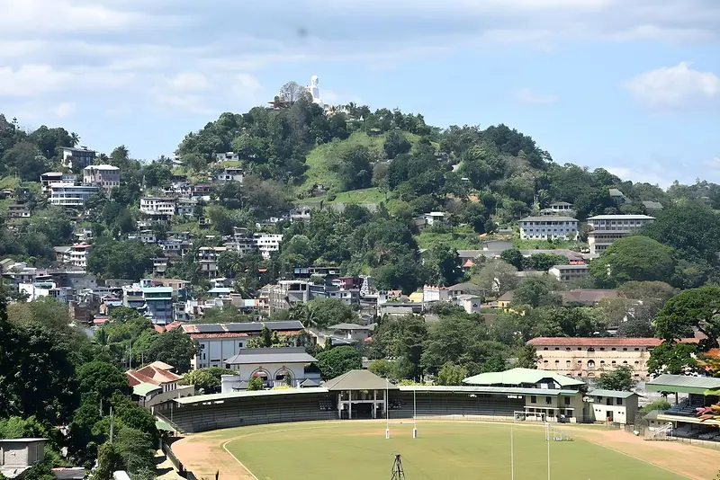 View over Kandy's hillside houses and a cricket ground from the guest house