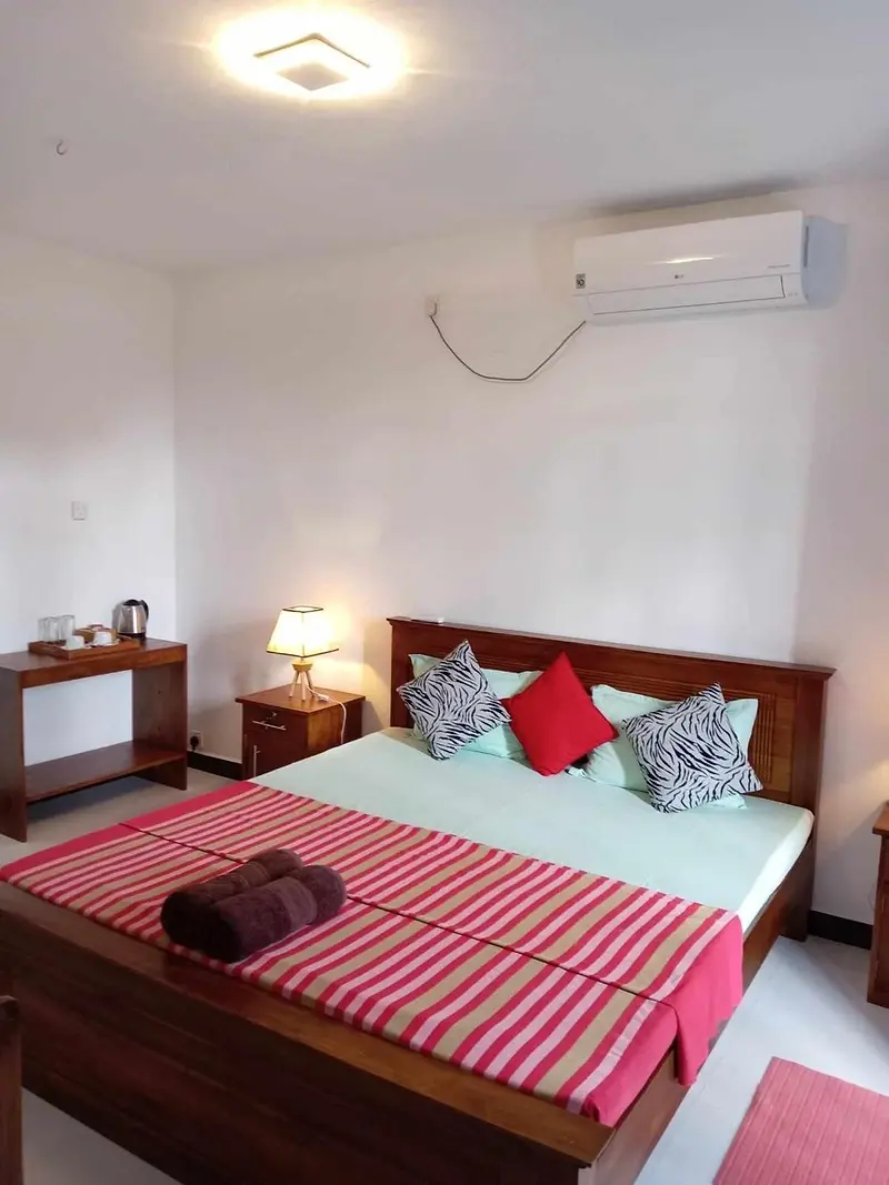 Double room with air conditioning and striped throw