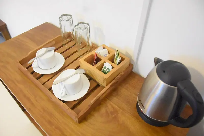 Tea and coffee tray with kettle on a teak desk